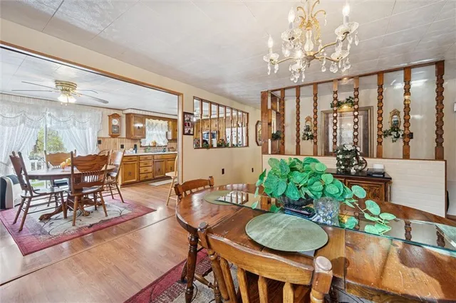 a dining room with furniture a livingroom view and chandelier