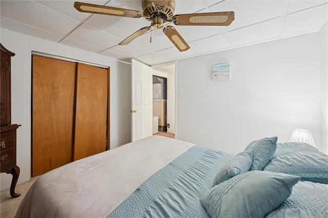 a bedroom with a bed couch and window