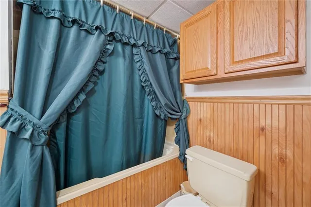 a bathroom with a toilet a sink and tub