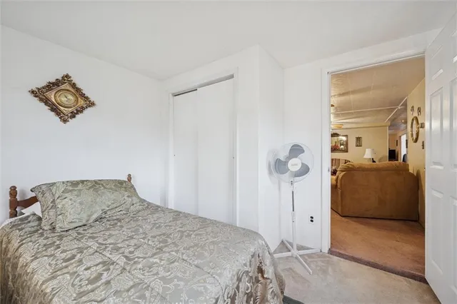 a bedroom with a bed and a lamp