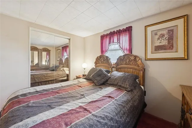 a bedroom with a large bed and a window