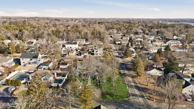 an aerial view of residential houses with city view
