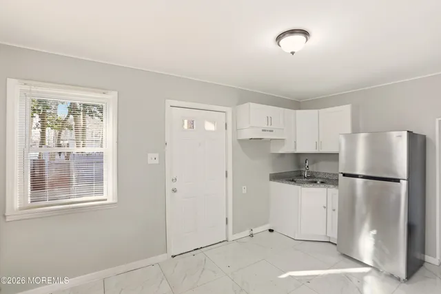 a kitchen with stainless steel appliances a refrigerator sink and cabinets