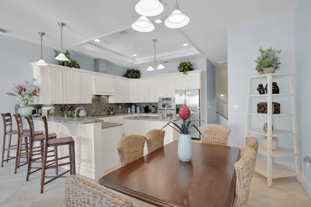 a kitchen with granite countertop a sink and white cabinets