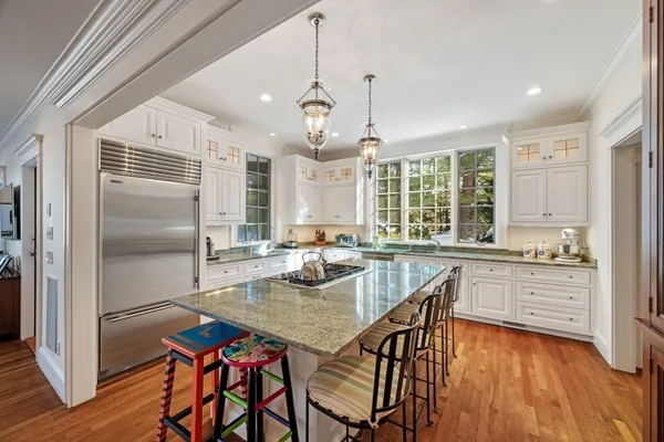 a open kitchen with stainless steel appliances granite countertop a stove and refrigerator