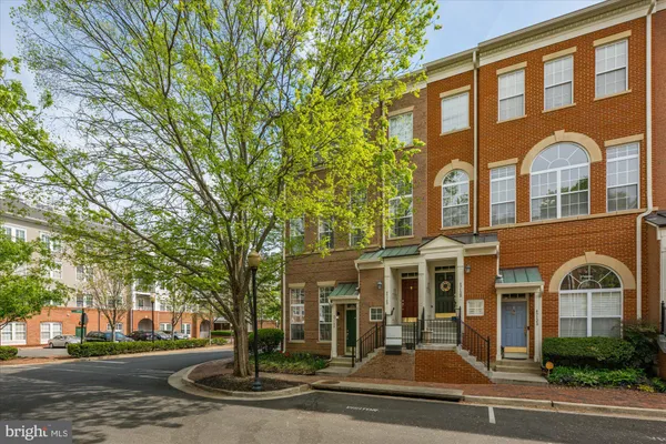 front view of a brick house with a yard