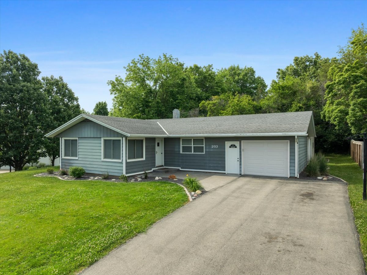 203 Highview Drive Eureka, IL 61530 - Photo 2 of 49 a front view of house with yard and trees in the background