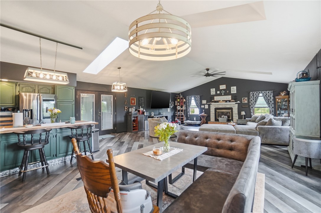 5209 North Addison New Carlisle Road St. Paris, OH 43072 - Photo 12 of 47 This expansive open concept living area boasts a fireplace and soaring vaulted ceilings.