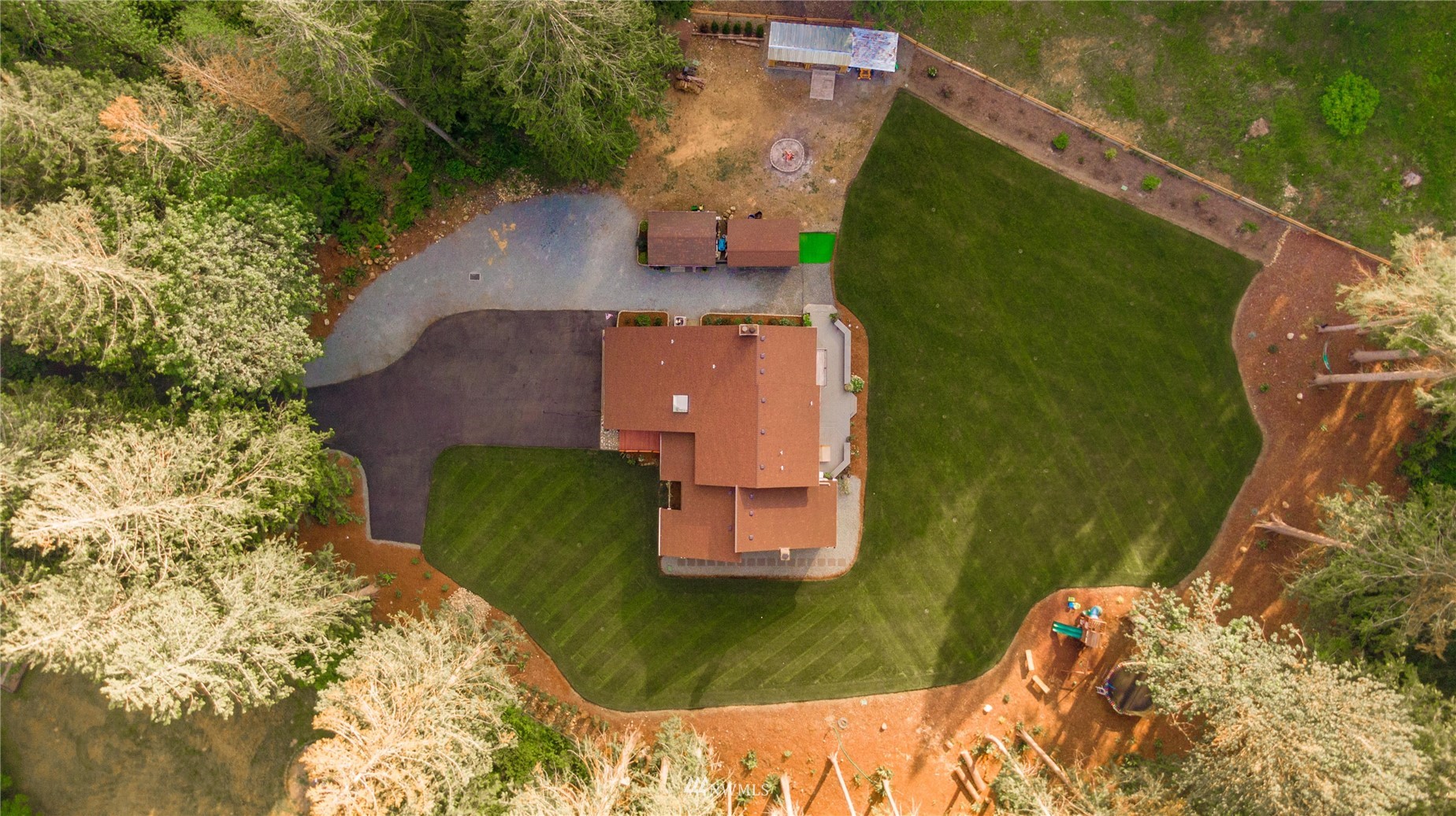 an aerial view of a house with a yard basket ball court and outdoor seating