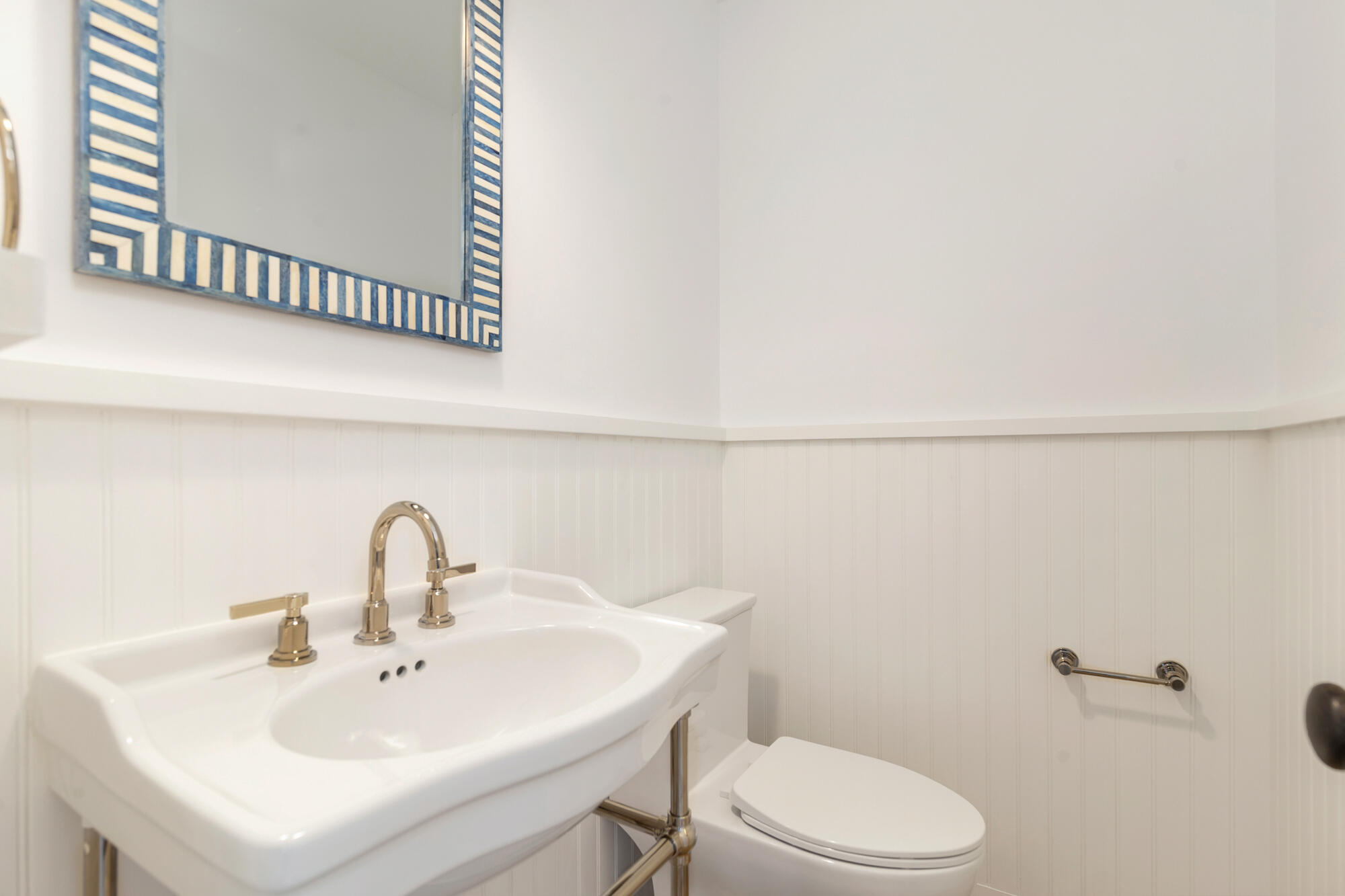222 South County Road Palm Beach, FL 33480 - Photo 15 of 21 a bathroom with a sink a toilet and a mirror