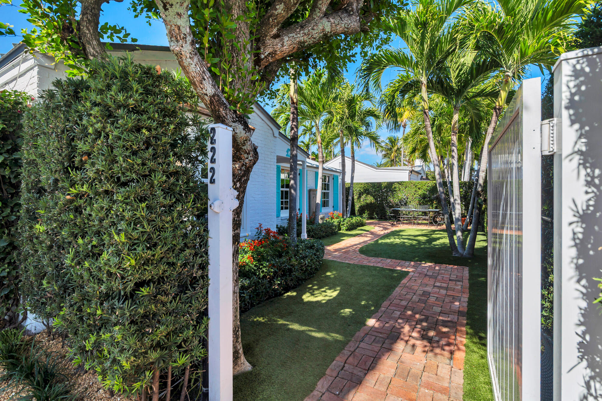 222 South County Road Palm Beach, FL 33480 - Photo 2 of 21 a view of a yard in front of a house with a tree
