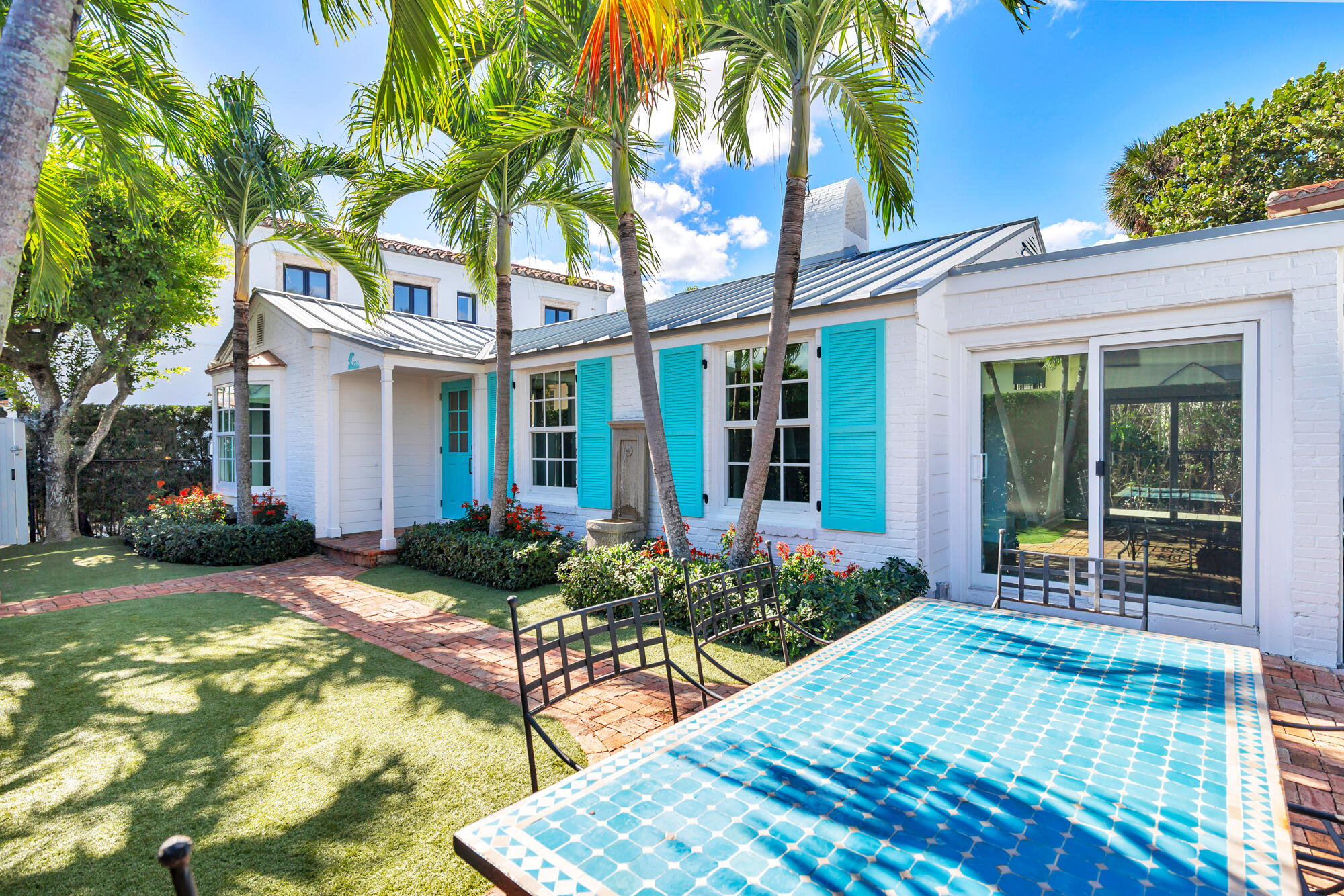 222 South County Road Palm Beach, FL 33480 - Photo 4 of 21 a view of a house with backyard sitting area and garden