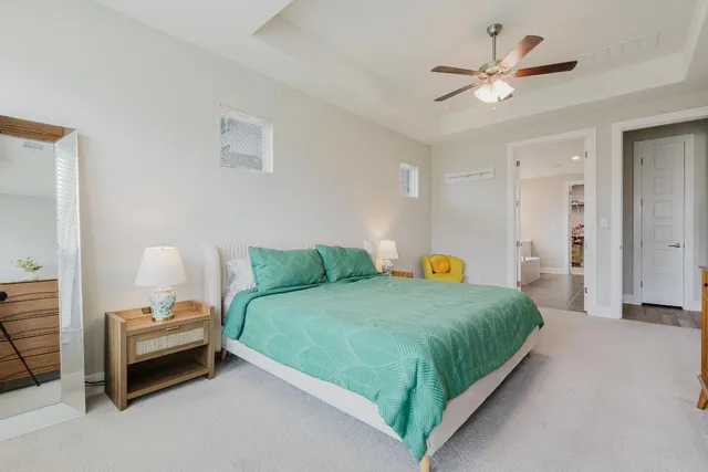 a bedroom with a bed and a chandelier