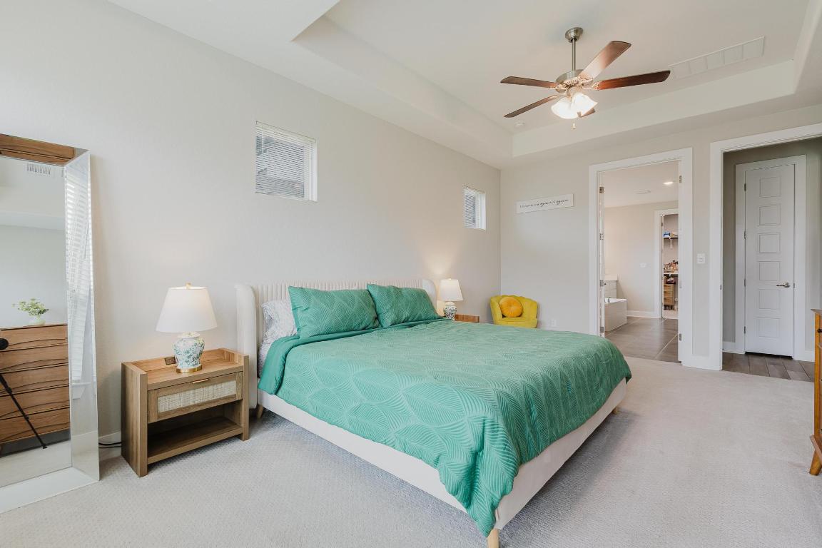 1104 Lickety Lane Georgetown, TX 78633 - Photo 15 of 40 a bedroom with a bed and a chandelier