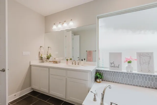 a bathroom with a sink vanity and mirror