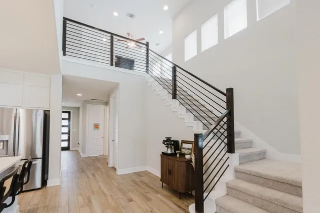 a view of entryway and hall with wooden floor
