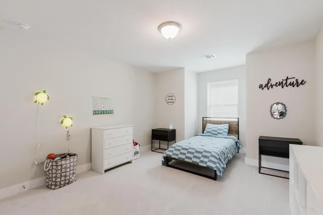 a bedroom with a bed and a table