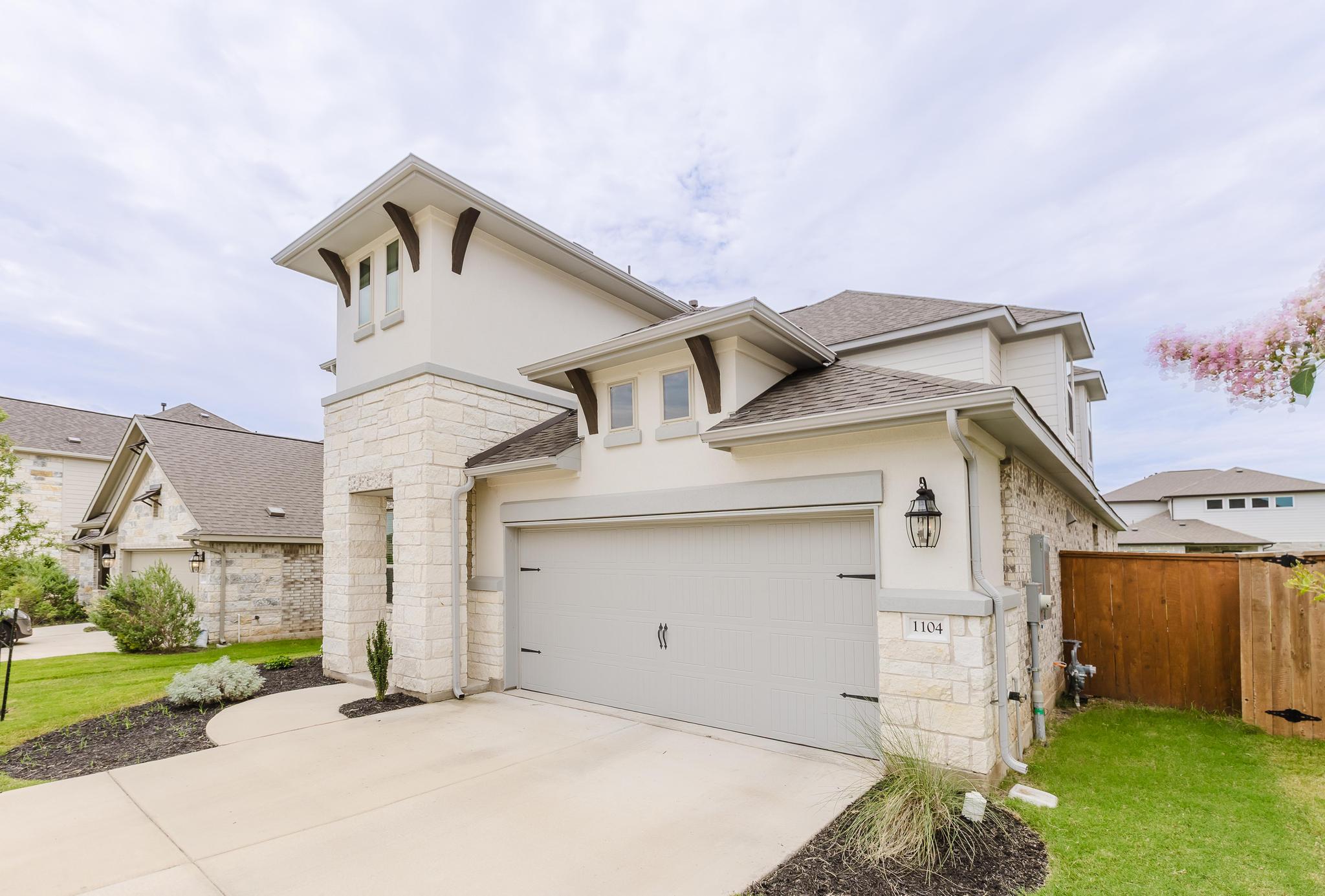 1104 Lickety Lane Georgetown, TX 78633 - Photo 3 of 40 View of front of house with stone siding, roof with shingles, stucco siding, and driveway