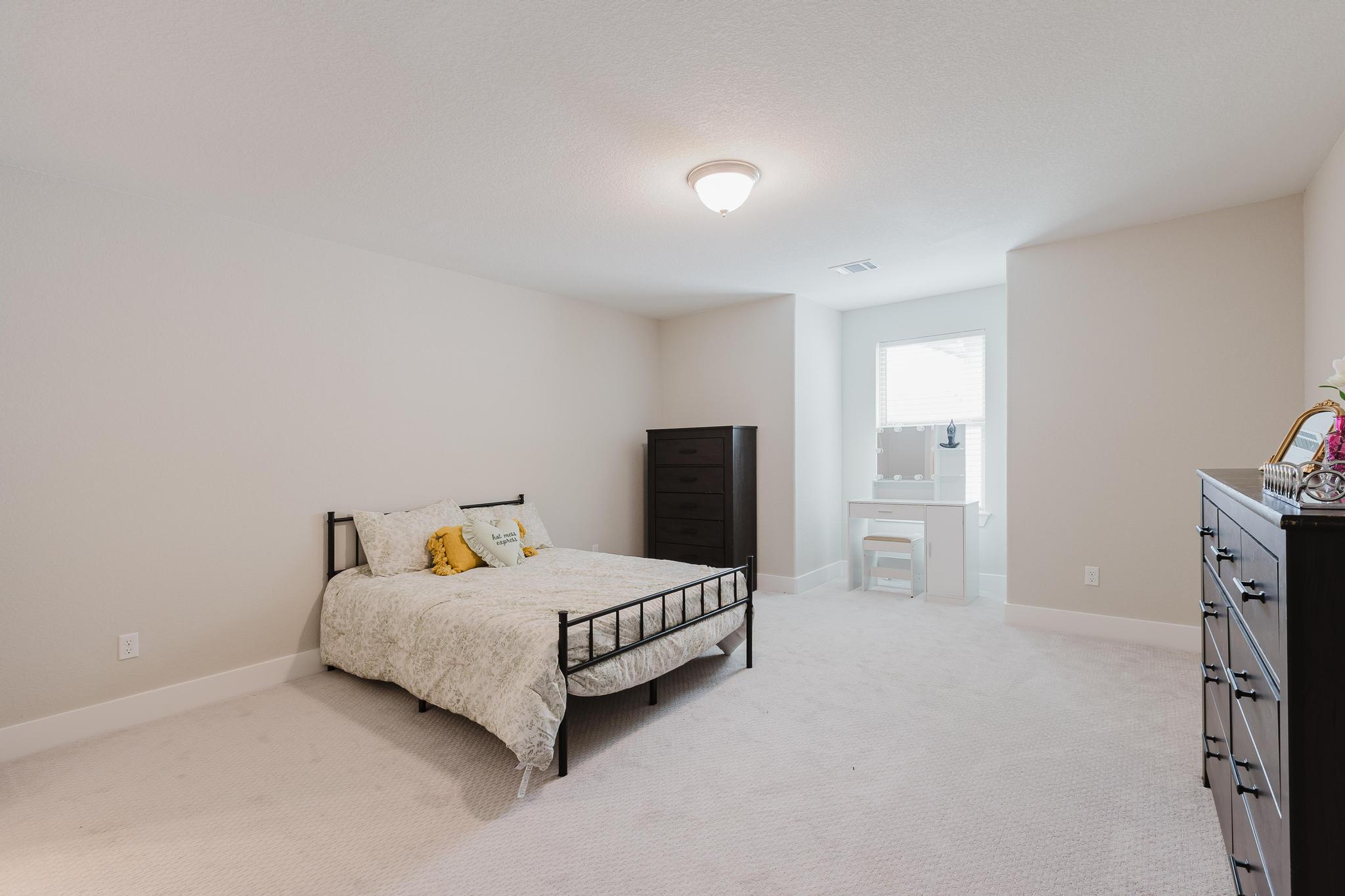 1104 Lickety Lane Georgetown, TX 78633 - Photo 31 of 40 a bedroom with a bed and dresser