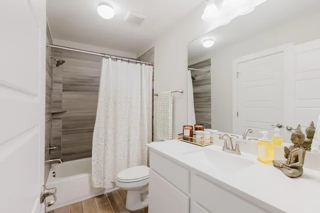 a bathroom with a sink toilet and shower