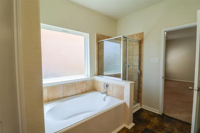 a white toilet sitting next to a shower