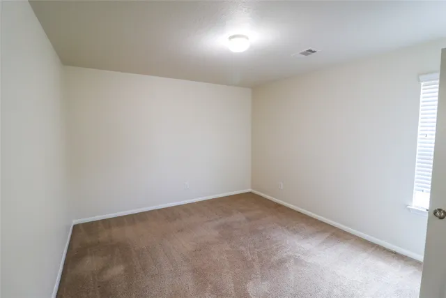 an empty room with closet area