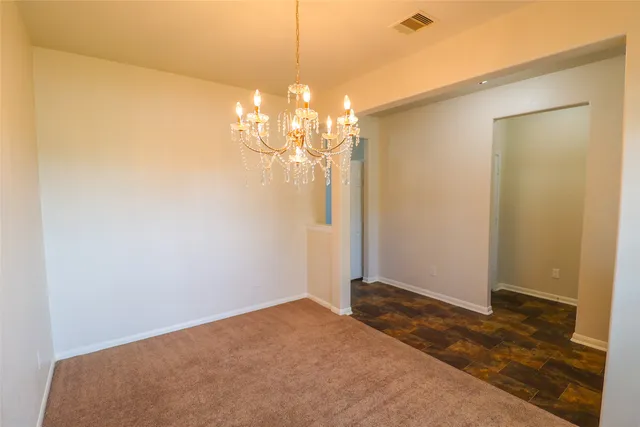 a view of a chandelier in big room and chandelier fan