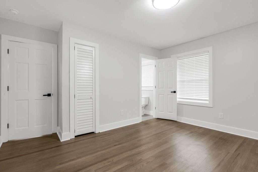 2219 Sharon Way Decatur, GA 30032 - Photo 19 of 23 an empty room with wooden floor and windows