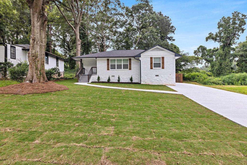 2219 Sharon Way Decatur, GA 30032 - Photo 2 of 23 a front view of a house with a yard and trees