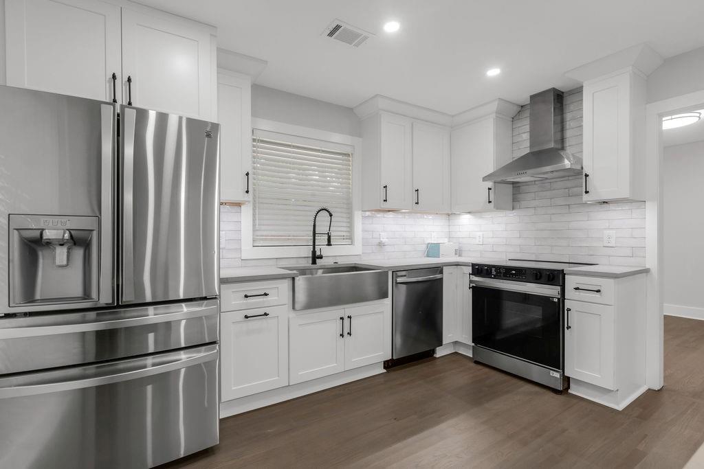 2219 Sharon Way Decatur, GA 30032 - Photo 6 of 23 a kitchen with stainless steel appliances and white cabinets