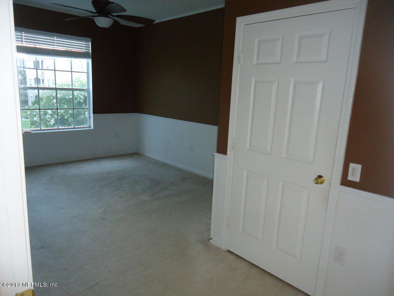7990 Baymeadows Road East, Unit 1023 Jacksonville, FL 32256 - Photo 21 of 39 an empty room with windows