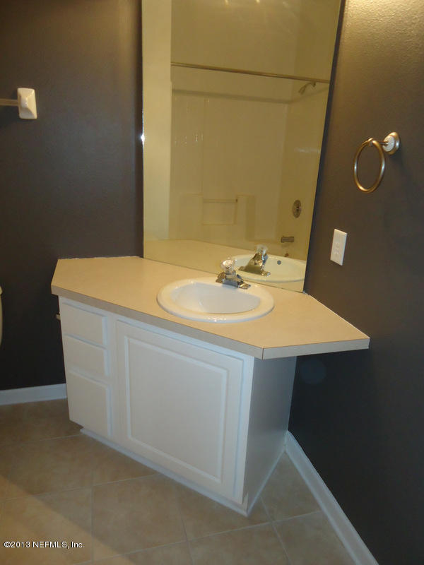 7990 Baymeadows Road East, Unit 1023 Jacksonville, FL 32256 - Photo 24 of 39 a bathroom with a sink and a mirror