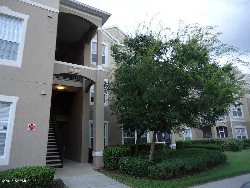 7990 Baymeadows Road East, Unit 1023 Jacksonville, FL 32256 - Photo 36 of 39 a front view of a house with a yard