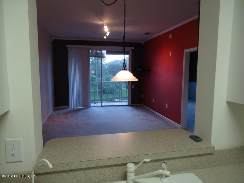 7990 Baymeadows Road East, Unit 1023 Jacksonville, FL 32256 - Photo 10 of 39 a view of a livingroom with a table and chairs