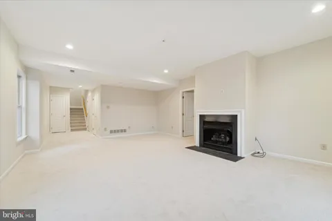 a view of a livingroom with a fireplace and window