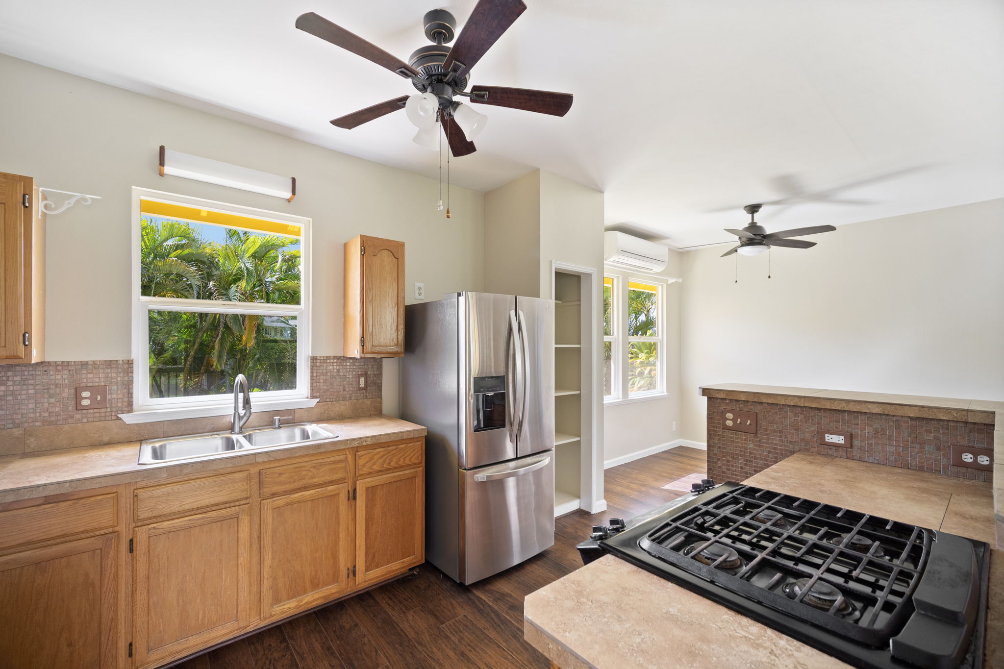 210 Eggerking Road Kapaa, HI 96746 - Photo 11 of 30 a kitchen with stainless steel appliances a refrigerator a sink a window and a counter space