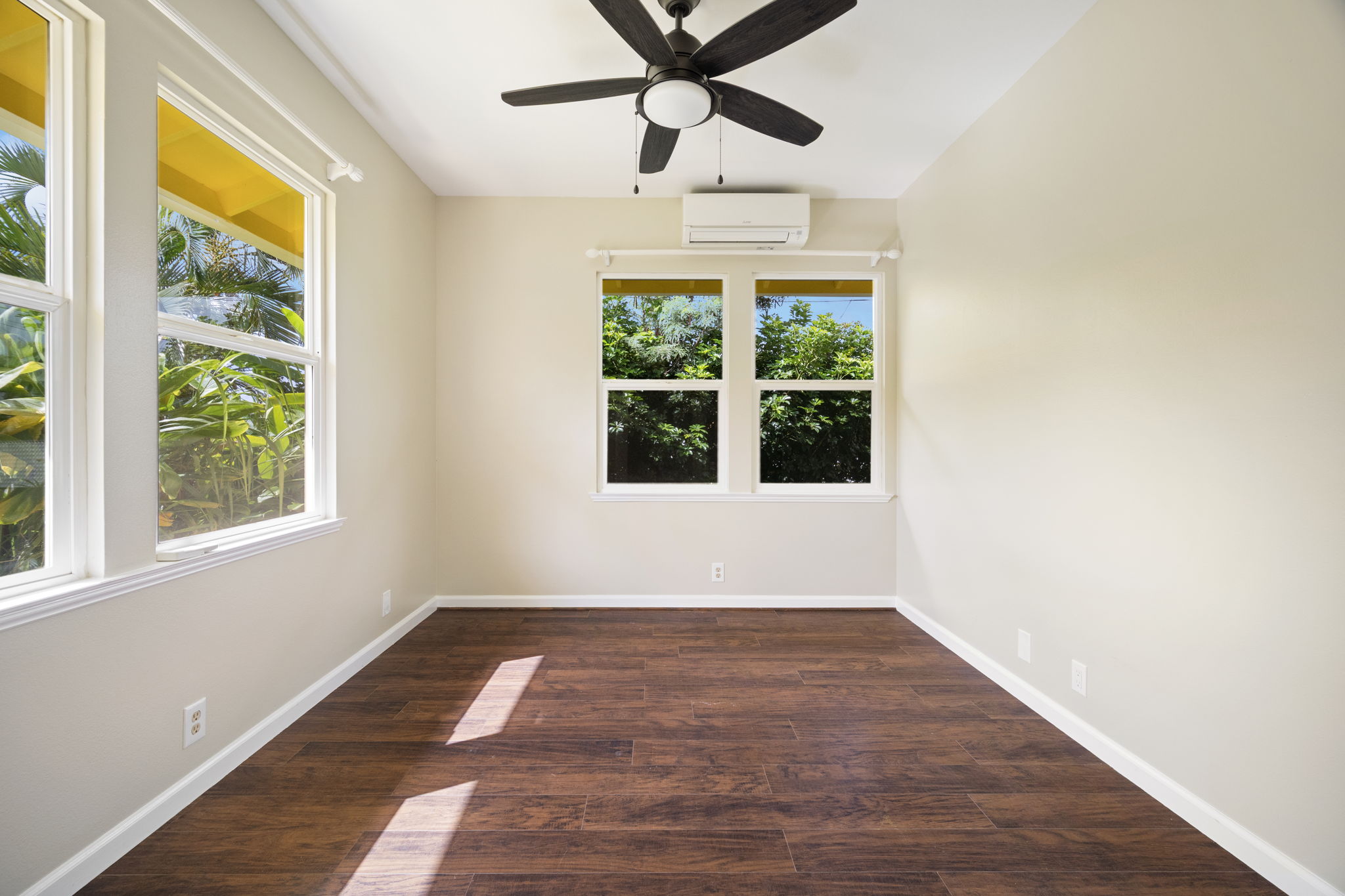 210 Eggerking Road Kapaa, HI 96746 - Photo 13 of 30 a view of an empty room with wooden floor and a window
