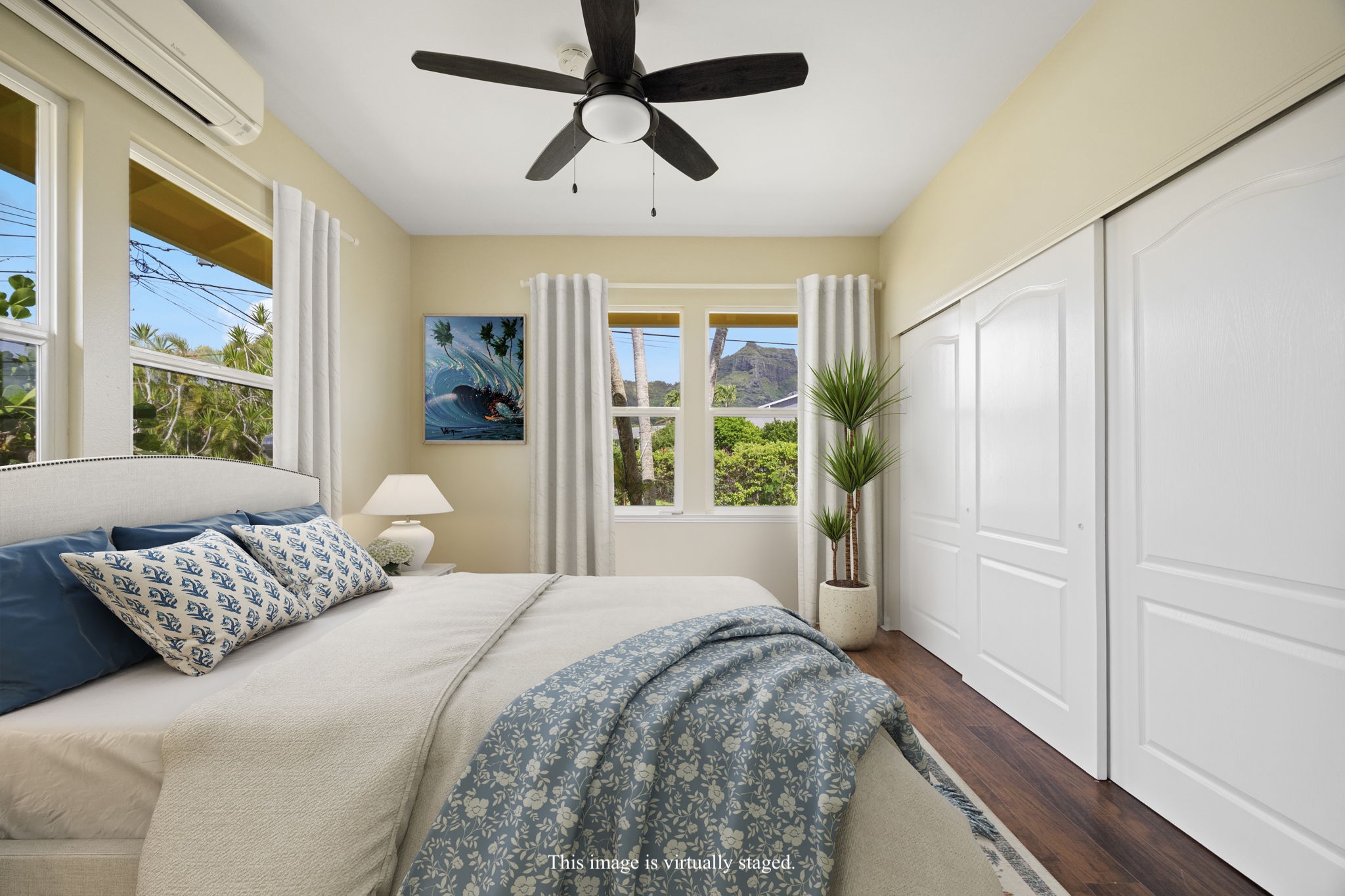 210 Eggerking Road Kapaa, HI 96746 - Photo 16 of 30 a bedroom with a large bed and a chandelier