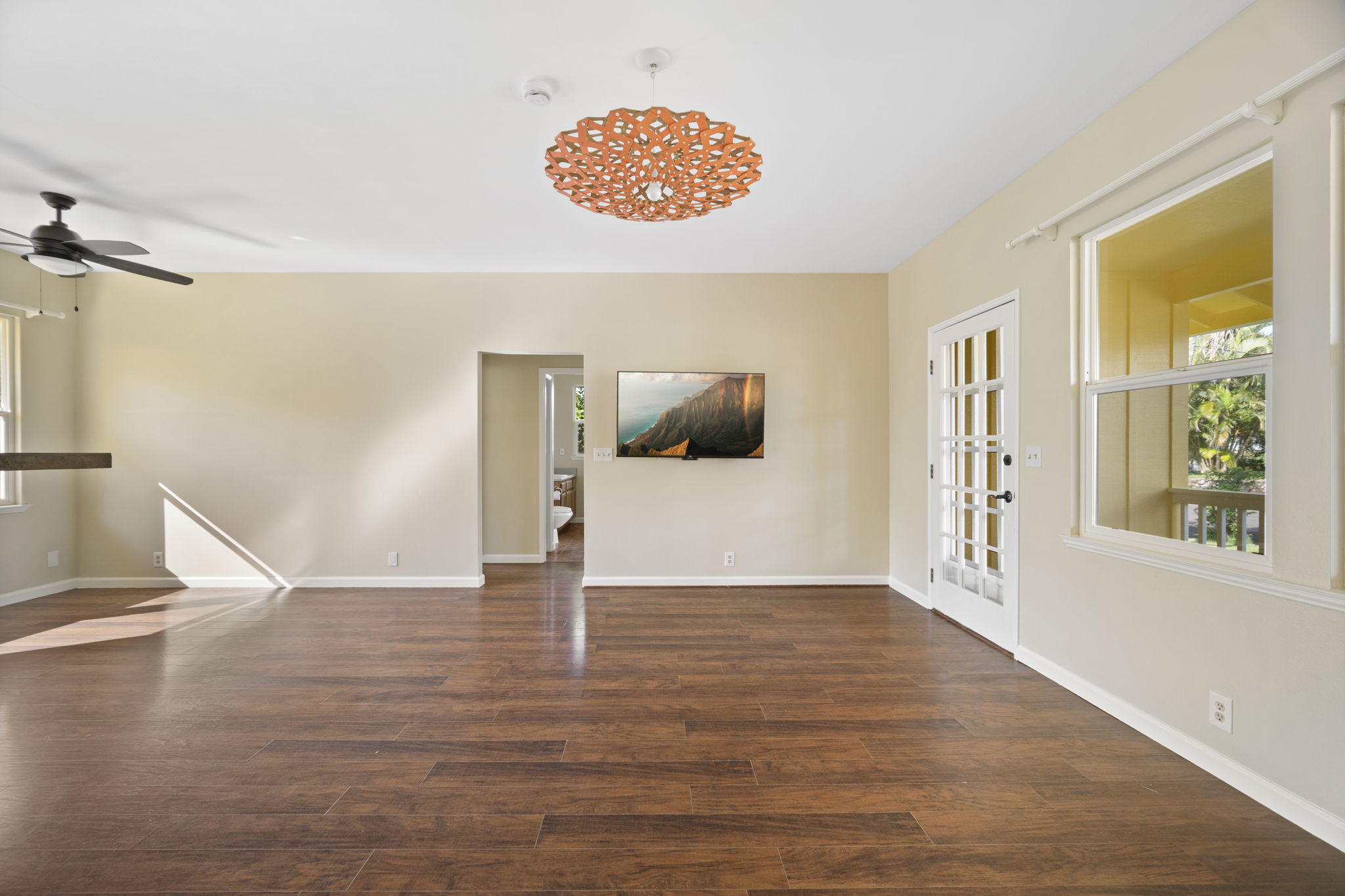 210 Eggerking Road Kapaa, HI 96746 - Photo 7 of 30 a view of an empty room with wooden floor and a window