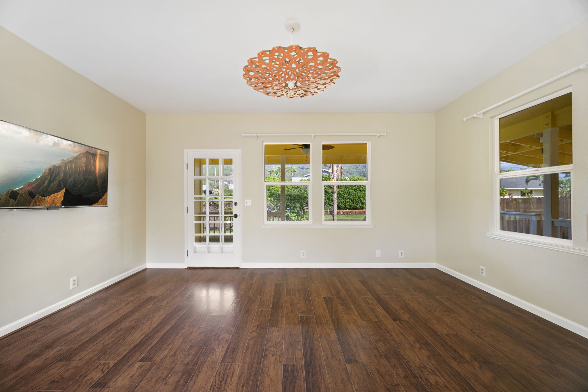 210 Eggerking Road Kapaa, HI 96746 - Photo 9 of 30 a view of an empty room with wooden floor and a window