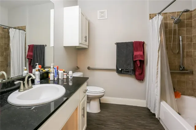 a bathroom with a sink toilet and shower