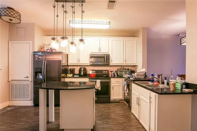 a kitchen with a sink stove and refrigerator
