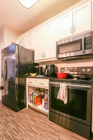 a stove top oven sitting inside of a kitchen