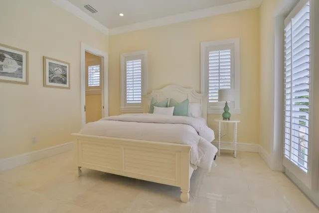 a bedroom with two beds and a window