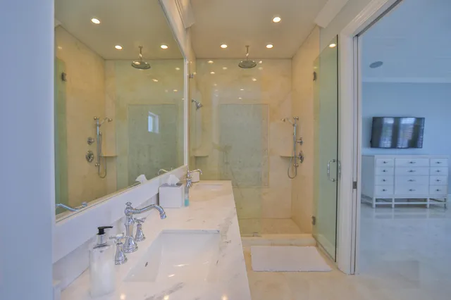 a bathroom with a sink a toilet and a shower