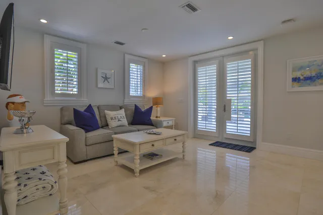 a spacious bedroom with a bed and a dresser in it