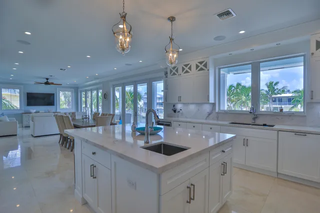 a kitchen with white cabinets and appliances