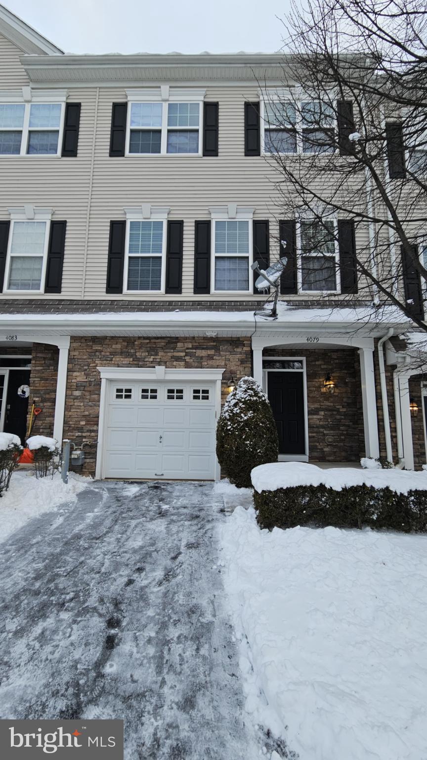 Charming townhouse blanketed in winter snow.