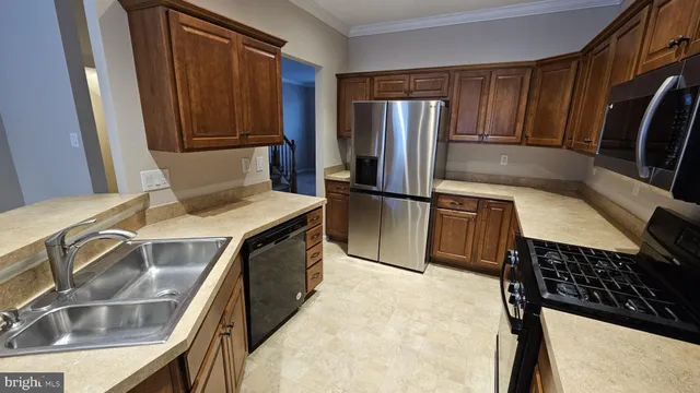 a kitchen with wooden cabinets and a stove top oven