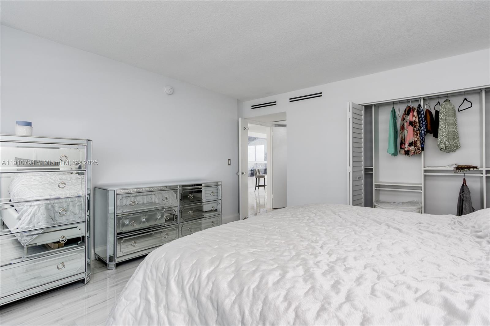 1200 South Ocean Boulevard, Unit 9F Boca Raton, FL 33432 - Photo 17 of 55 a bedroom with a bed and a dresser